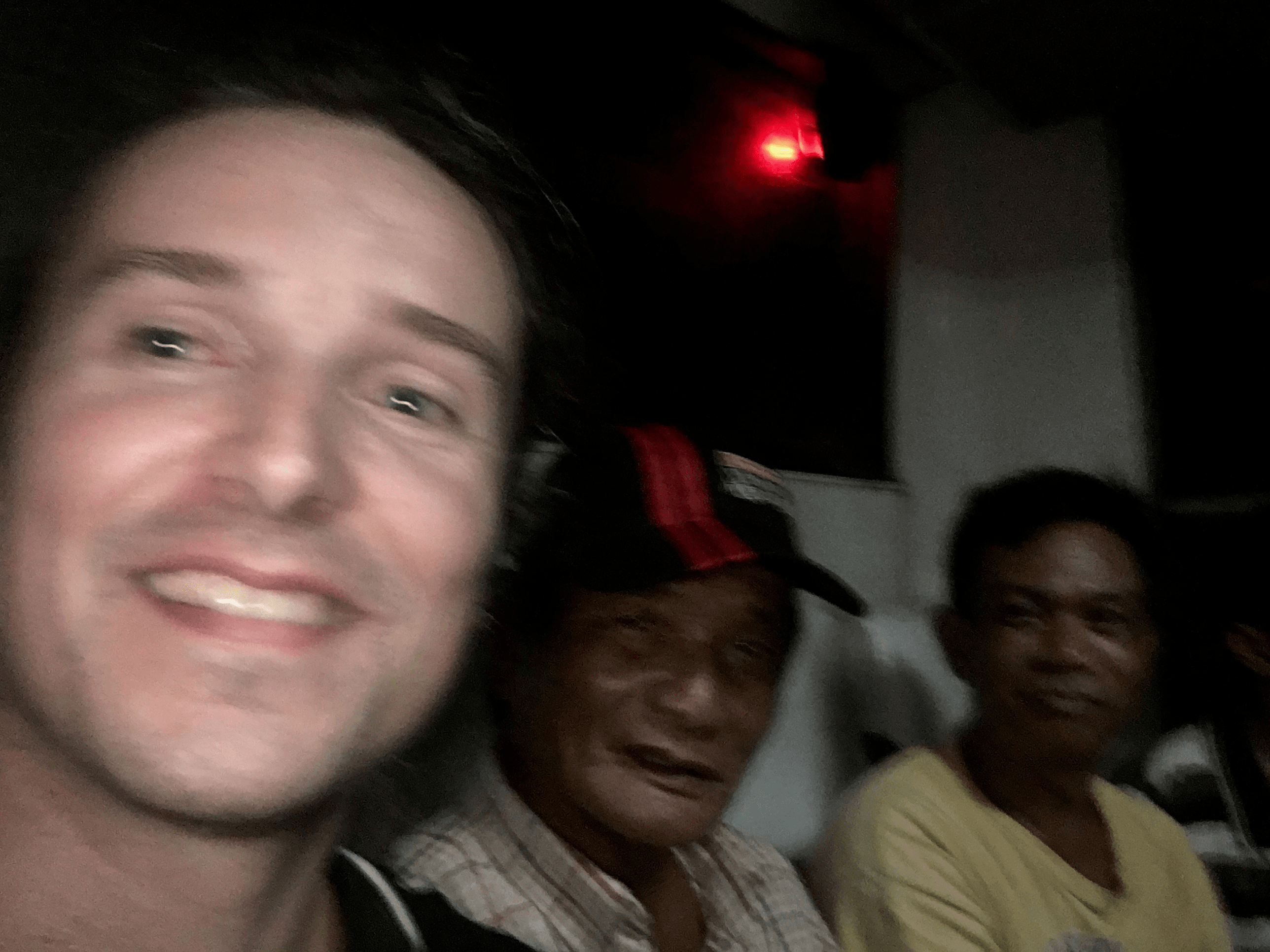 lenny through paradise taking a selfie with filipino men in the bus in the philippines pangasinan
